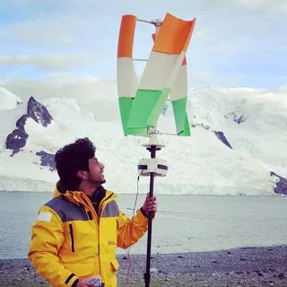 Vijay in Antarctica beside the tricolour printed turbine.