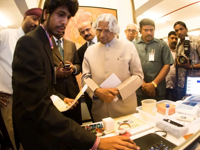 Vijay demonstrating an early Braille display prototype to Dr A.P.J. Abdul Kalam.